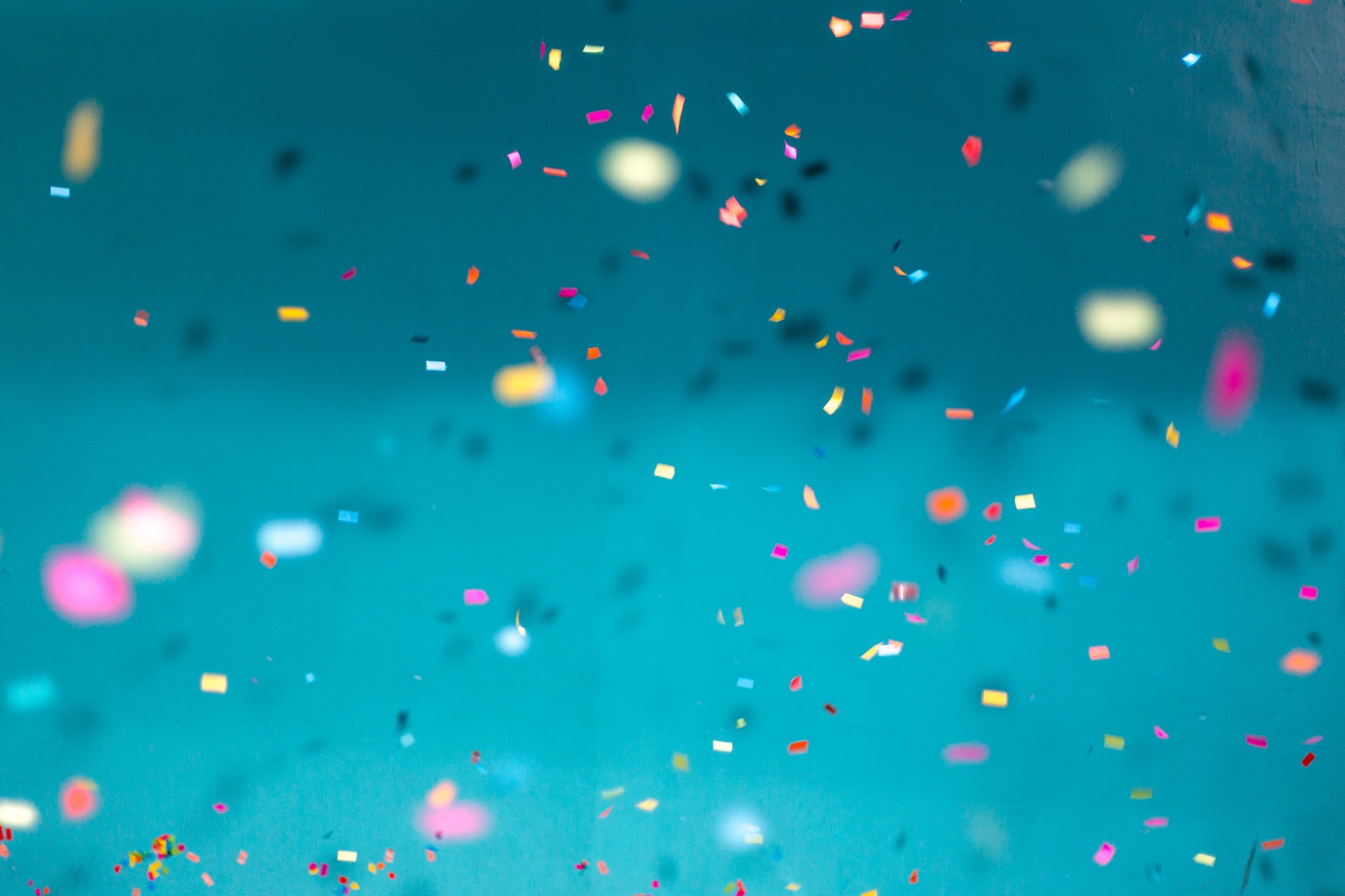 
		Confetti against a pale blue background.		